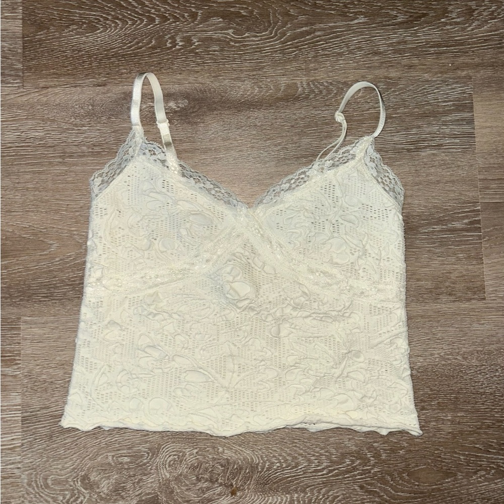 Urban Outfitters cream crop top with flower and lace details.